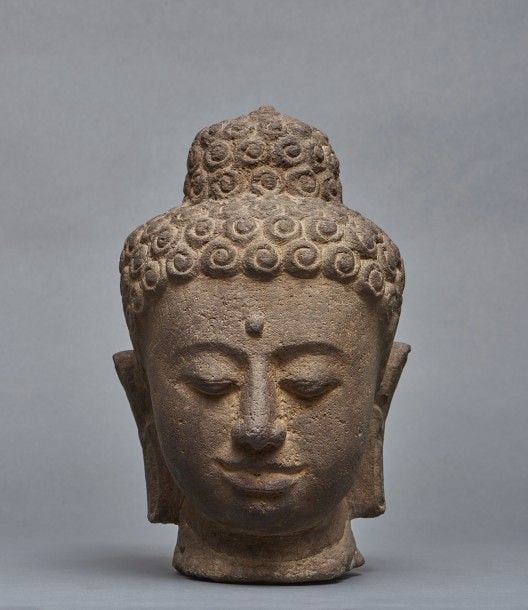 Tête de bouddha en pierre sur un socle en bois noi