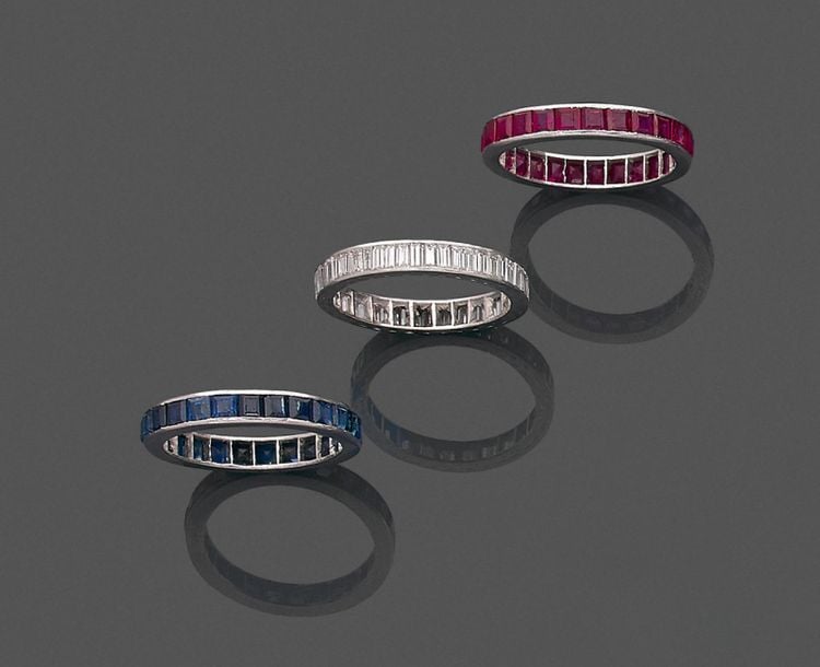 •Trois ALLIANCES en platine (min 800‰) chacune serti de diamants taille baguette, rubis et saphirs calibré