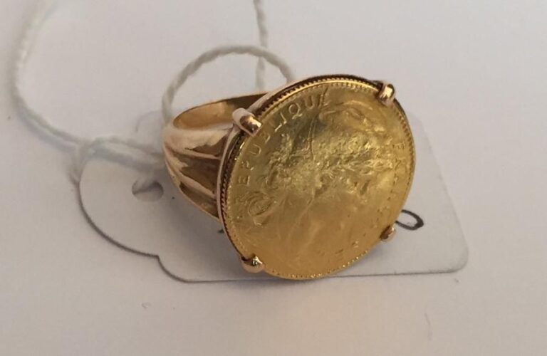 Une pièce de 10 francs or montée en bague en or jaune 18 ct (750 milième