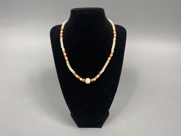 Collier formé de perles de corail blanc et orange (Corallium spp) . Fermoir en…