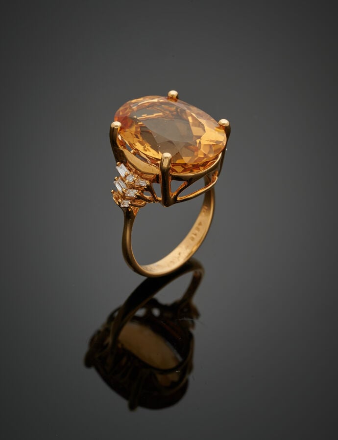 BAGUE ovale en or jaune (750‰) ajouré, serti d'une citrine ovale épaulée de onz…