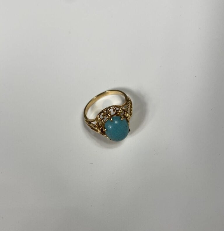 Bague en or jaune (585) texturé à monture ajourée ornée d'un cabochon de turquo…