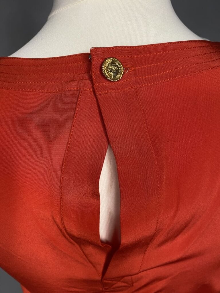 CHANEL - Blouse sans manche à encolure ronde en soie rouge, fermeture par un bo…