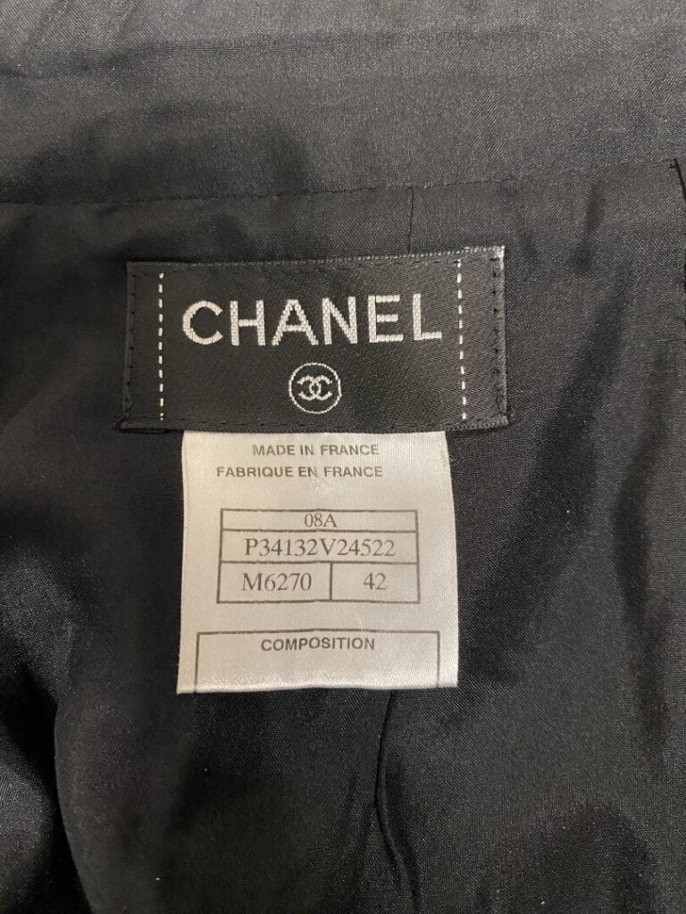 CHANEL - Jupe droite en laine et soie noire à motif moucheté bleu nuit, fermetu…