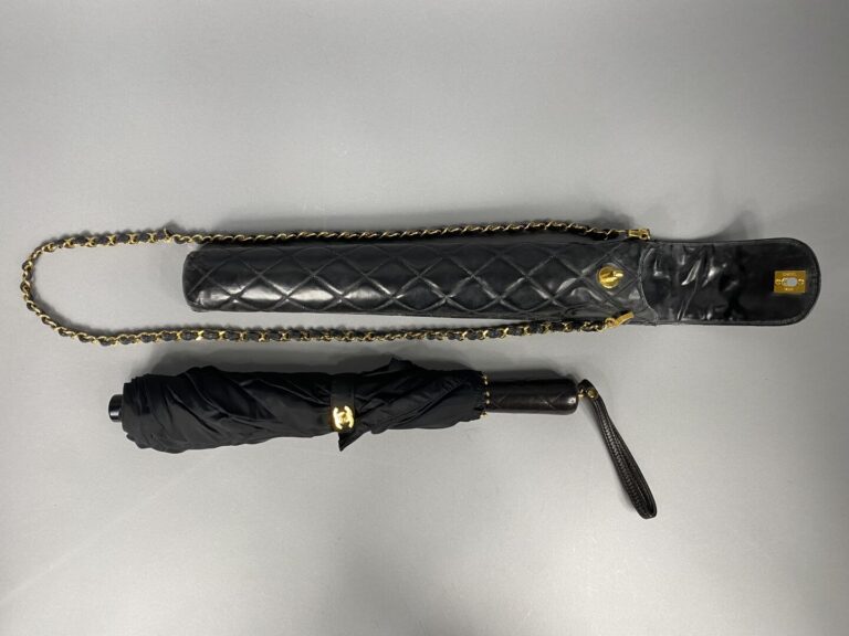 CHANEL - Parapluie en nylon noir avec son étui en cuir matelassé noir, chaîne e…