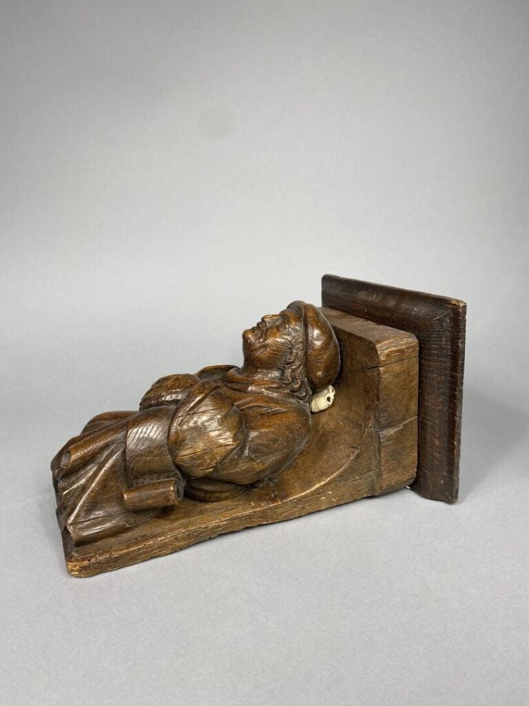Petite console d'applique en chêne sculpté formée d'un personnage tenant un phy…