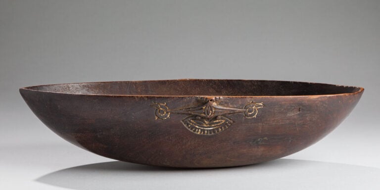 Ancien bol a nourriture de forme ovale et orné de chaque côté d'un motif représ…