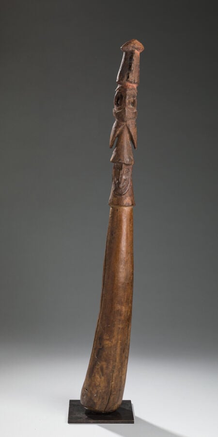 Ancien pilon représentant une structure complexe surmonté d'une tête Janus. - B…