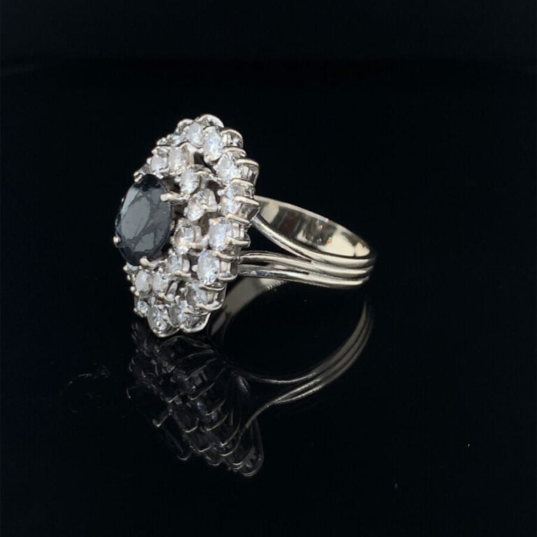 BAGUE « Pompadour » en or gris (750‰) ajouré, serti d'un saphir ovale foncé (ég…