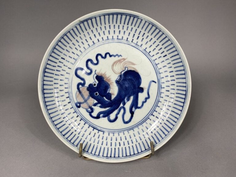 Chine - Plat en céramique émaillée bleu blanc à décor de chien de Fô - Diam. :…
