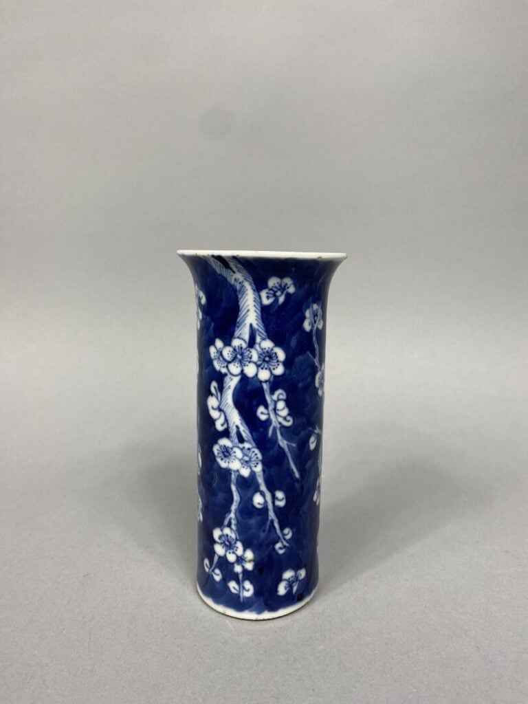 Chine - Vase cornet en porcelaine bleu blanc à décor de prunus sur fond bleu -…