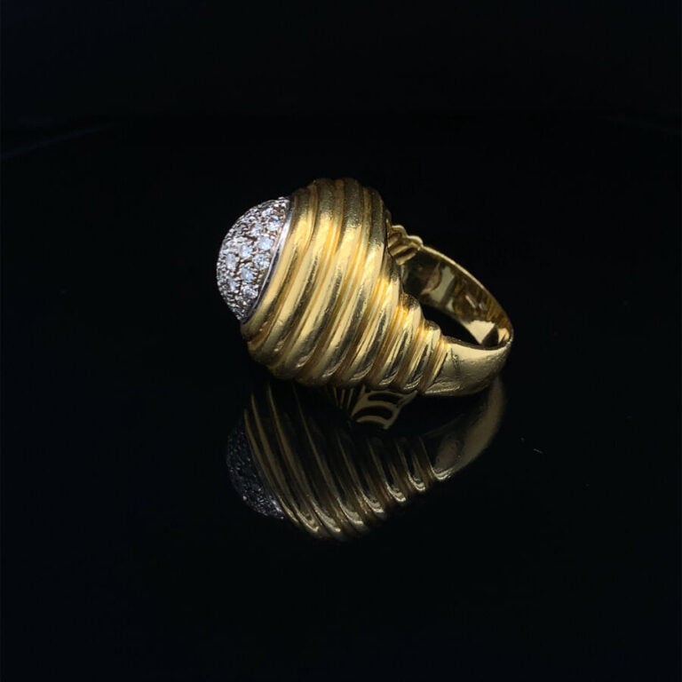 Importante BAGUE « dôme » en or jaune et or gris (750‰) godronné, surmonté d'un…