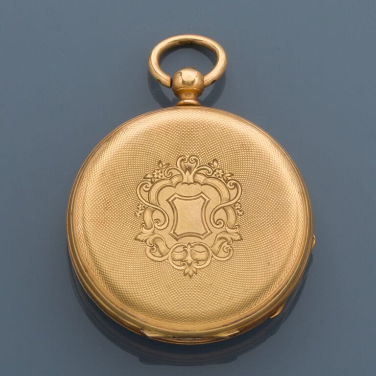 MONTRE de POCHE en or jaune (750‰) finement guilloché et ciselé à décor de volu…