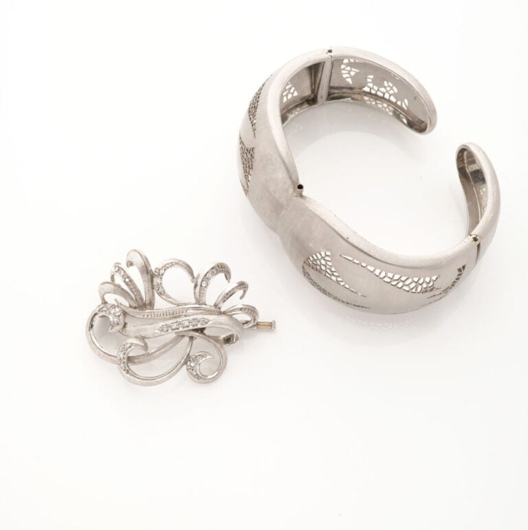 Bracelet manchette ouvrant articulé en or gris (750) amati, centré d'une broche…