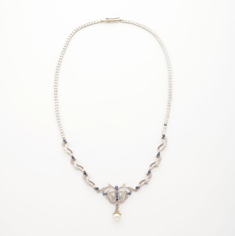 Collier en or gris (750) formé d'une maille articulée, le décolleté souligné d'…