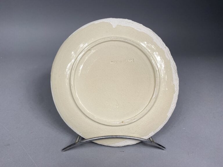 MADURA - Assiette en faience émaillée dans les tons bruns et noirs à décor d'un…