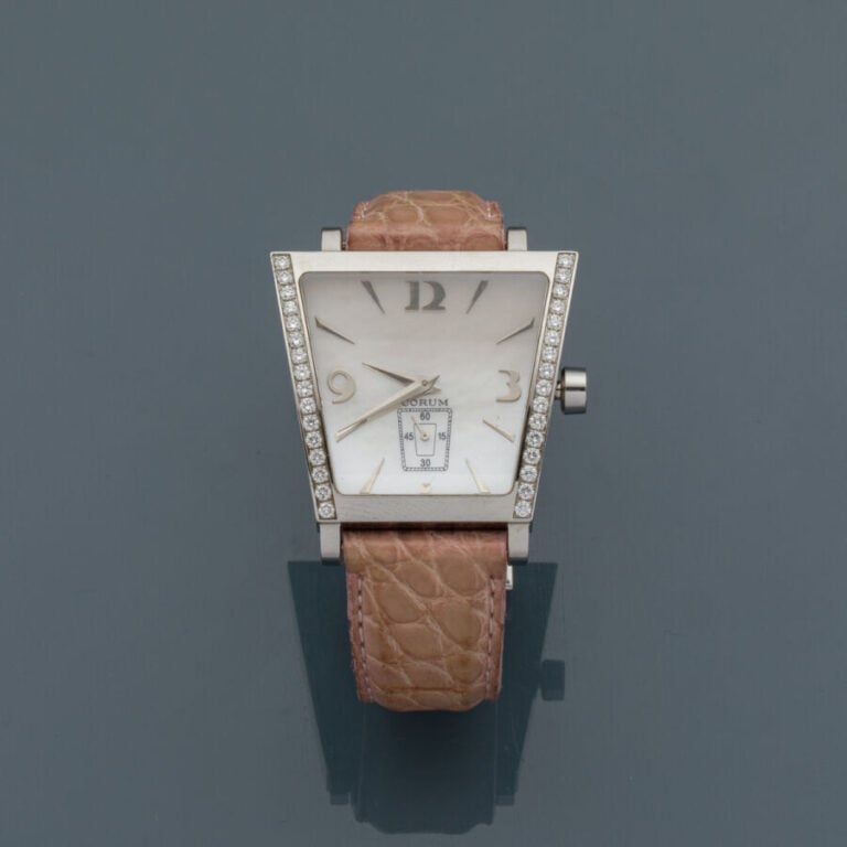 CORUM - BRACELET MONTRE « Trapèze » en acier. Lunette partiellement sertie d'al…