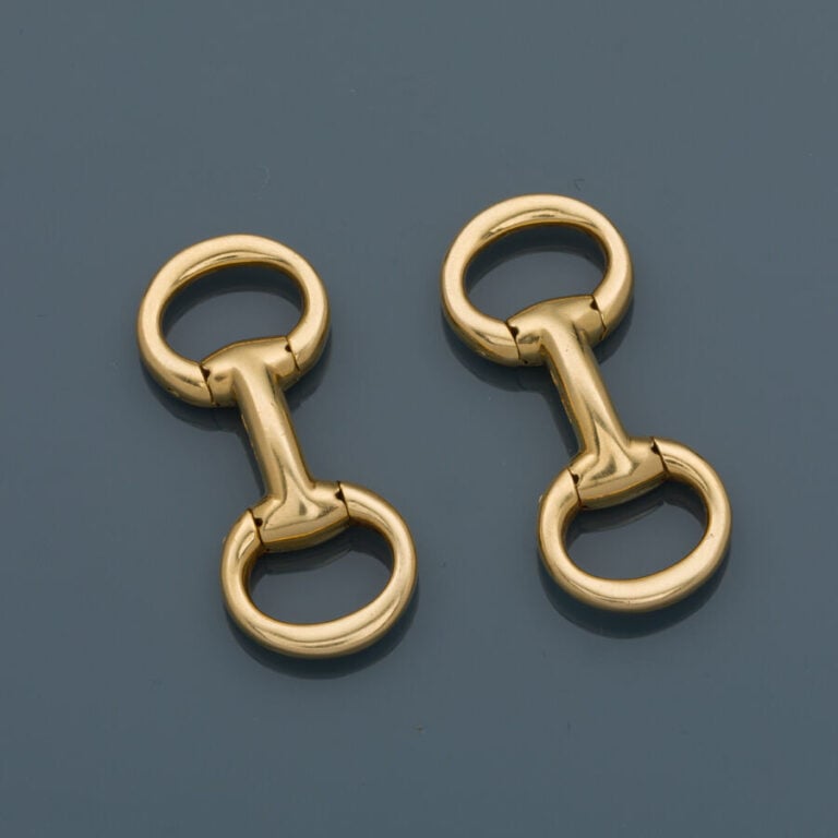 HERMES - Paire de BOUTONS de MANCHETTE "Mors" en or jaune (750‰). - Signée HERM…
