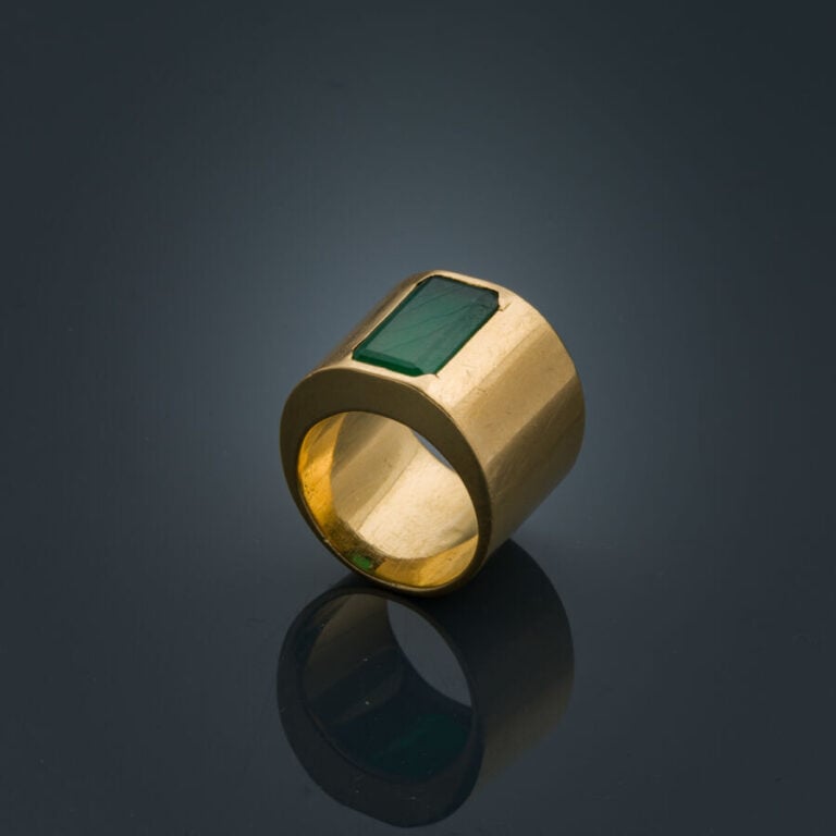 Large BAGUE plate en or jaune (750‰) serti d'une émeraude taillée à degrés (égr…