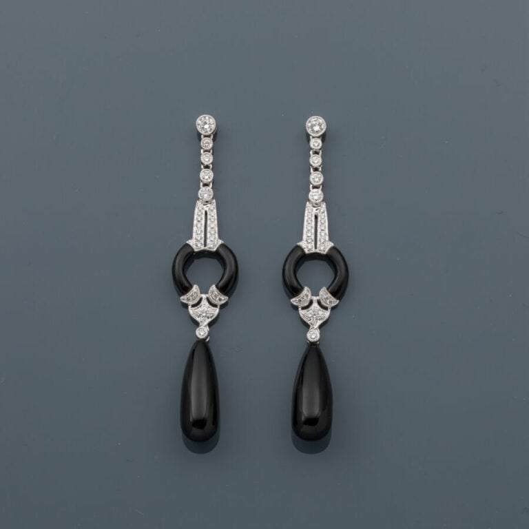 Longue paire de PENDANTS D'OREILLES en or gris (750‰) articulé et ajouré serti…
