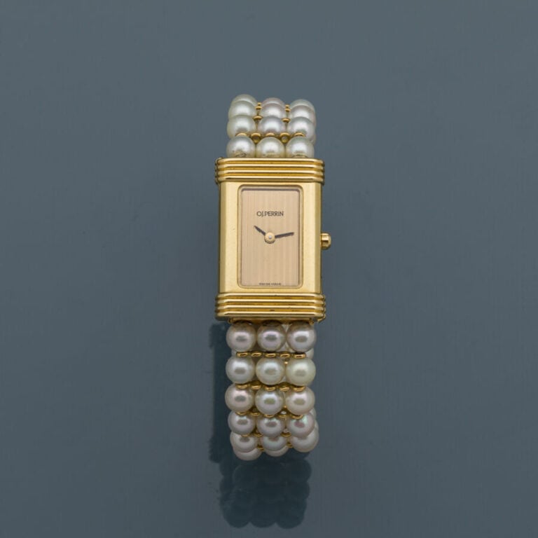 O.J. PERRIN - BRACELET MONTRE de dame rectangulaire en or jaune (750‰). Lunette…