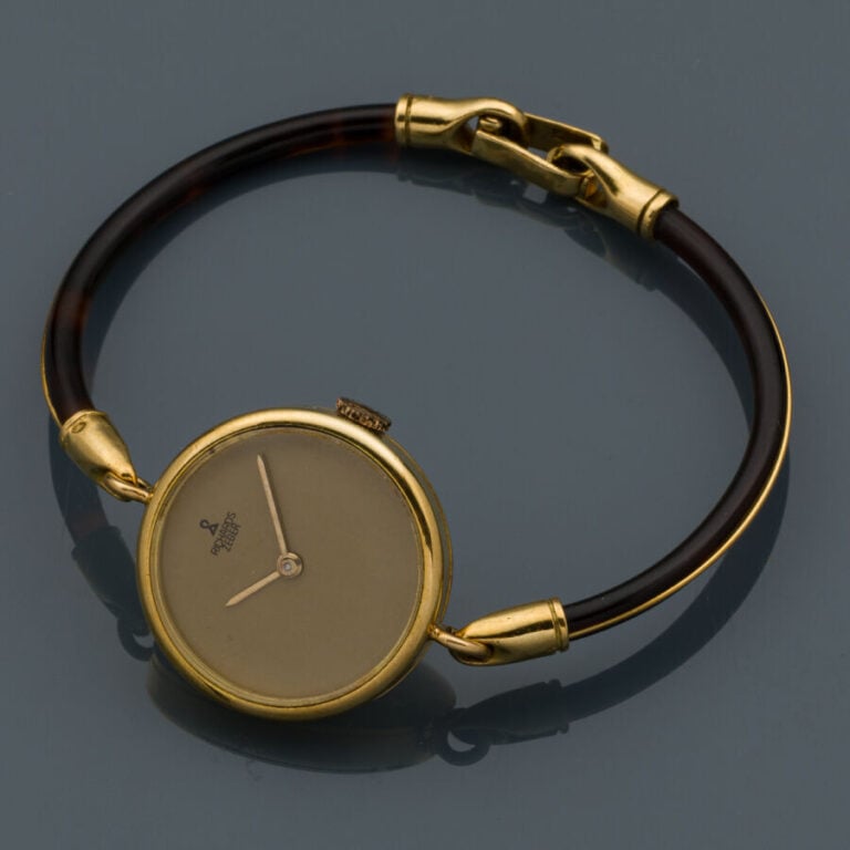 RICHARDS ZEGER - BRACELET MONTRE ronde de dame en or jaune (750‰). Cadran champ…