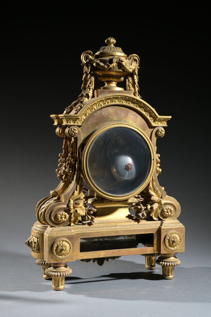 Importante pendule borne en bronze ciselé doré surmontée d'une cassolette reten…