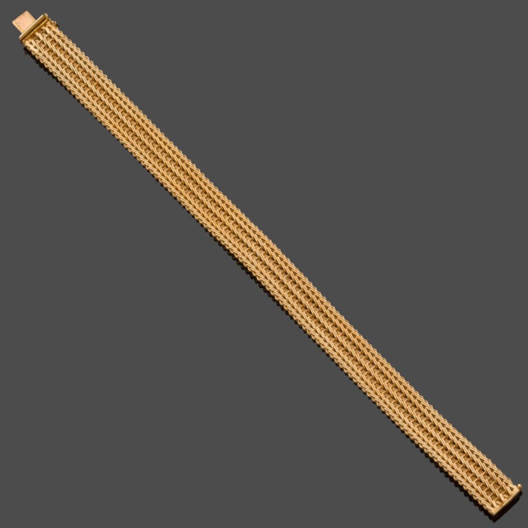 BRACELET souple en or jaune (750‰) ajouré. - Long. : 18,5 cm. Larg. : 1 cm. Poi…