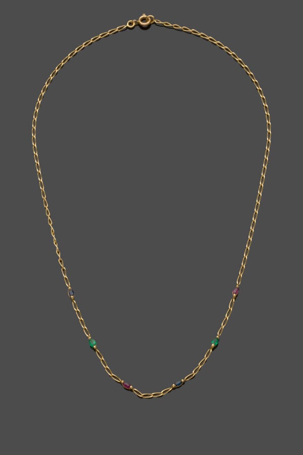 COLLIER composé d'une fine chaînette en or jaune (750‰) ajouré serti de rubis,…