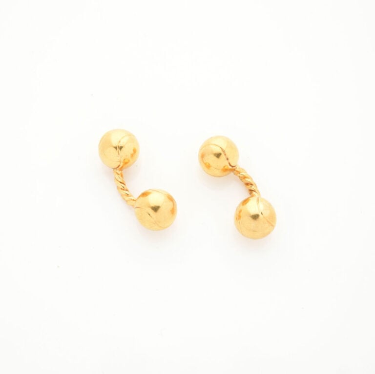 DUNHILL - Paire de BOUTONS de MANCHETTES "balles de tennis" en or jaune (750‰)…