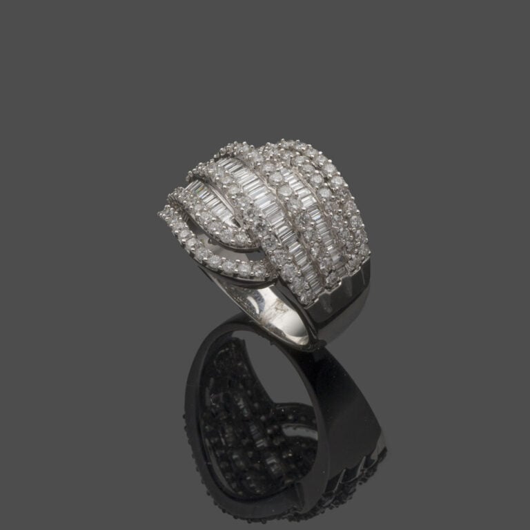 Large BAGUE "volutes" en or gris (750‰) ajouré, serti de six alignements de dia…