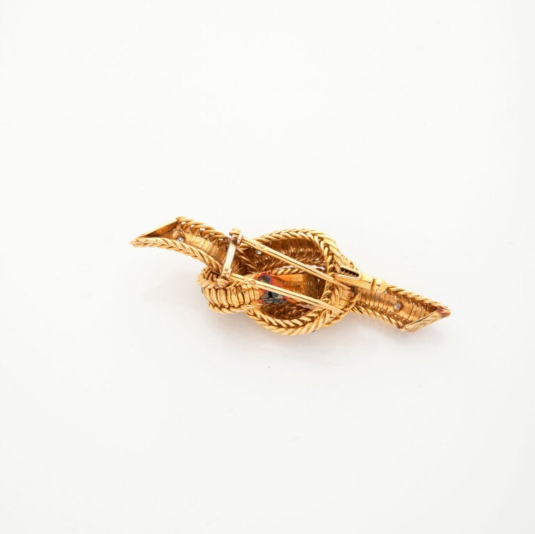STERLE Paris - BROCHE clip noeud articulé en or jaune et or gris (750‰) ponctué…