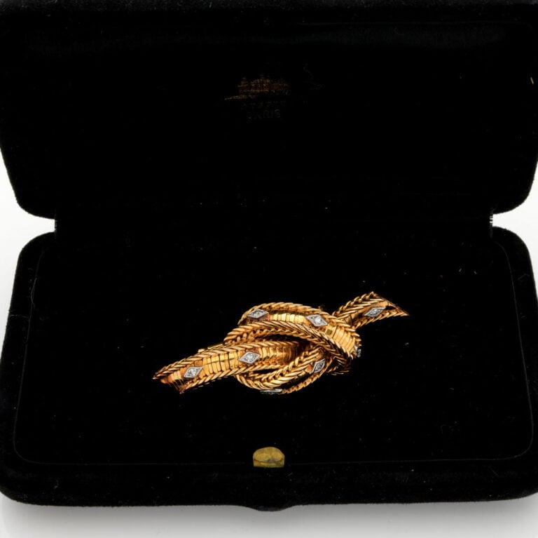STERLE Paris - BROCHE clip noeud articulé en or jaune et or gris (750‰) ponctué…