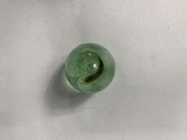 Presse-papiers ovoïde en verre vert orné en inclusion d'un motif floral en 3 di…