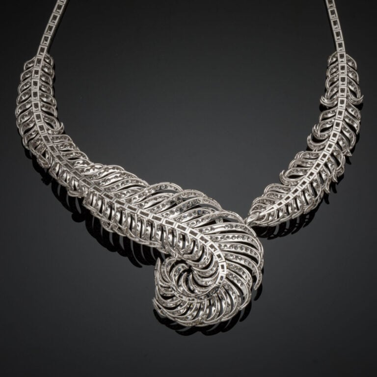 Important COLLIER "plume" en or gris (750‰) articulé et ajouré entièrement sert…