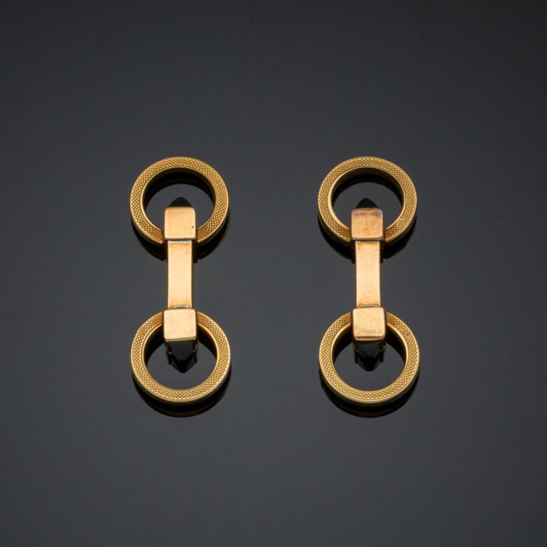 Paire de BOUTONS de MANCHETTES circulaires articulés en or jaune (750‰) partiel…
