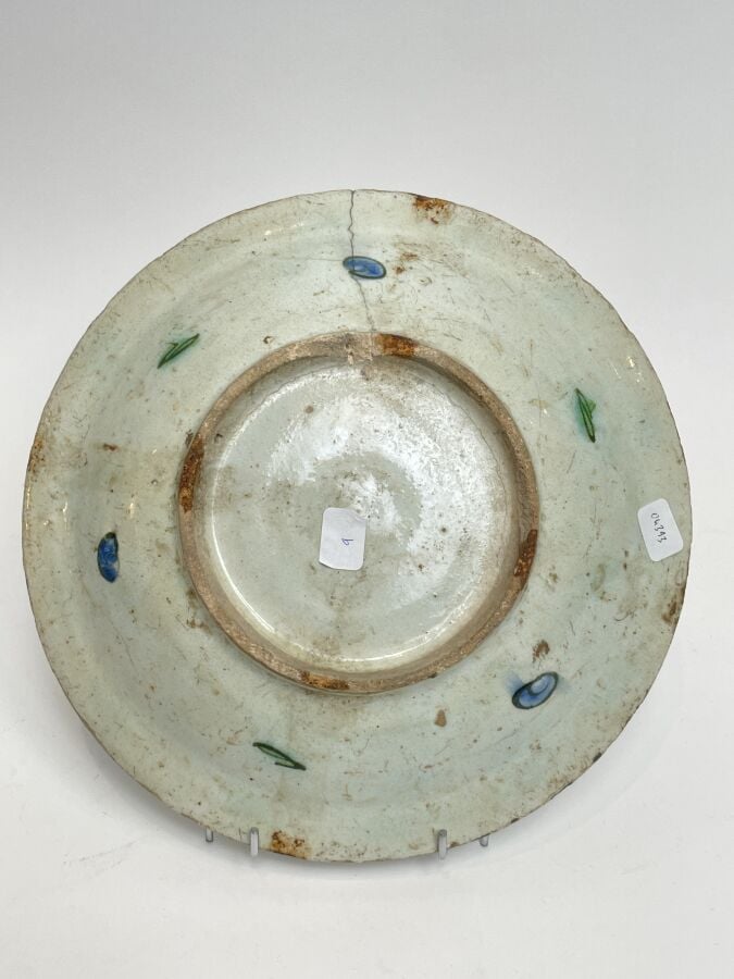 IZNIK , ASSIETTE à décor émaillé de tulipes (fêles, accidents) - XVIIIème siècl…