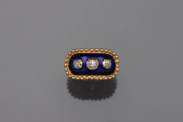 BAGUE de forme ovale en or jaune (750) perlé et orné d'émail translucide bleu f…