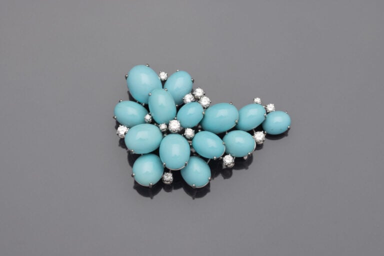 BROCHE " grappe " en or gris (750) ajouré, serti de cabochons de turquoises de…