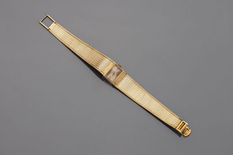 OMEGA - BRACELET MONTRE rectangulaire de dame en or jaune (750). Cadran crème (…