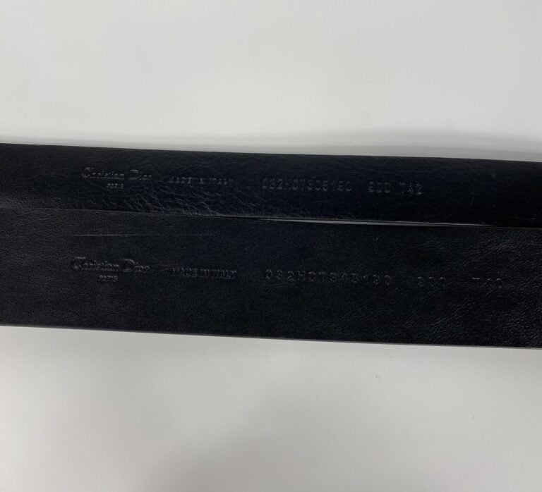 CHRISTIAN DIOR, circa 2000 - Lot de deux ceintures en cuir glacé noir et métal…