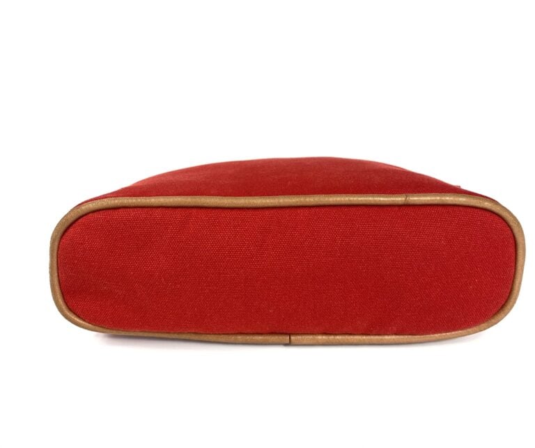 HERMÈS - Trousse de voyage "Bolide" en toile de coton rouge et cuir gold, modèl…