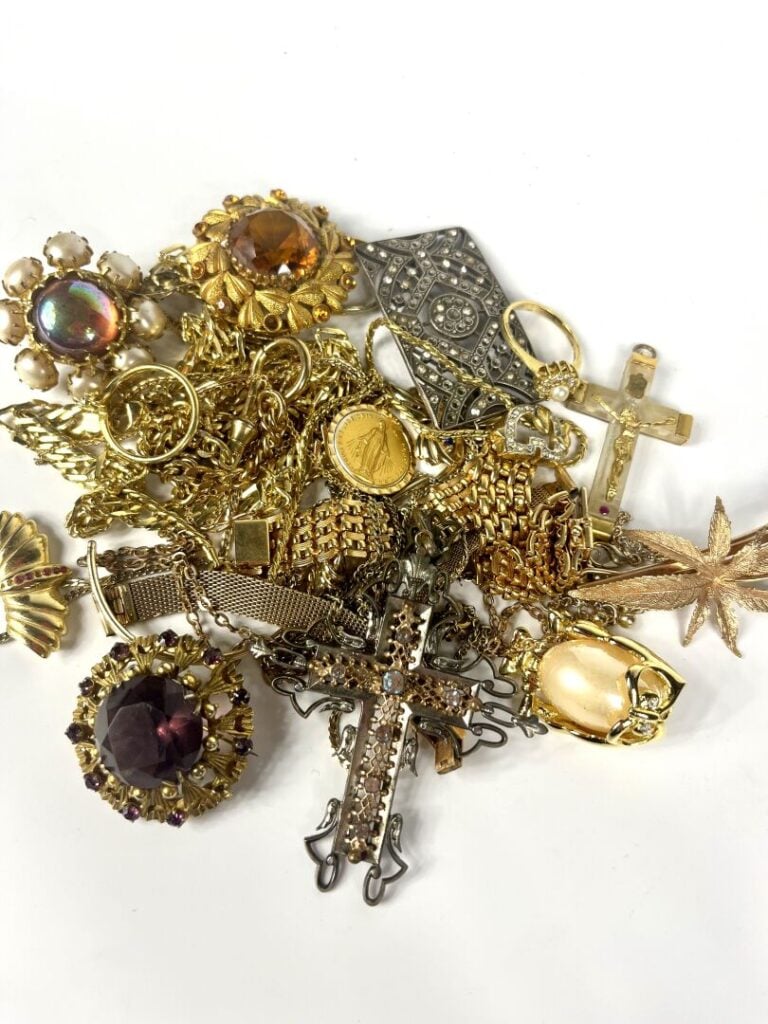 Lot de bijoux fantaisie comprenant notamment des colliers et broches dorés, pie…