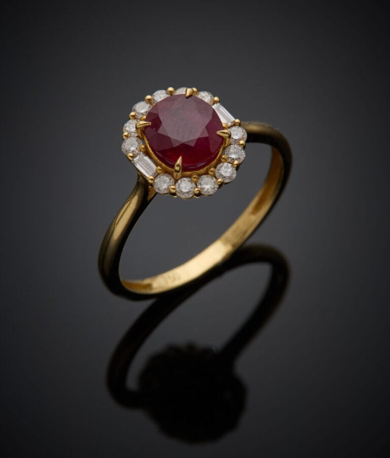 BAGUE en or jaune (750‰) serti d'un rubis ovale, entouré de diamants taille bri…