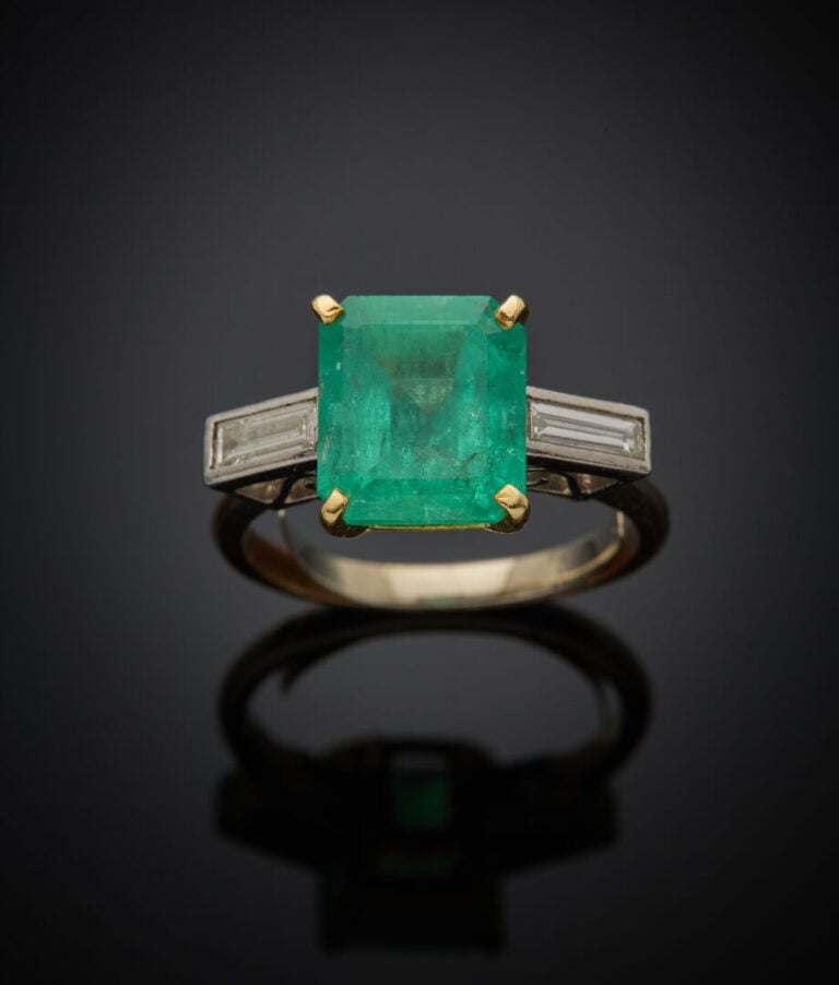 BAGUE en or jaune et or gris (750‰) serti d'une émeraude rectangulaire taillée…