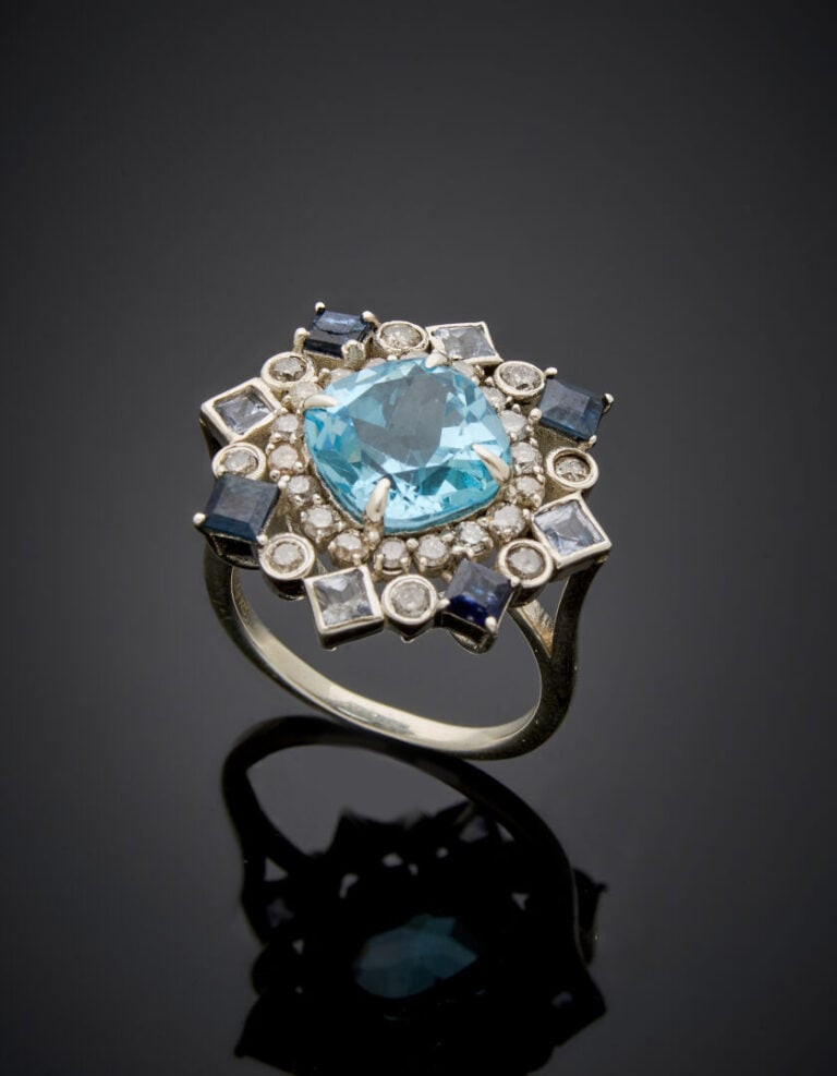 BAGUE "flocon" en argent (925‰) ajouré serti d'une topaze bleue de forme coussi…