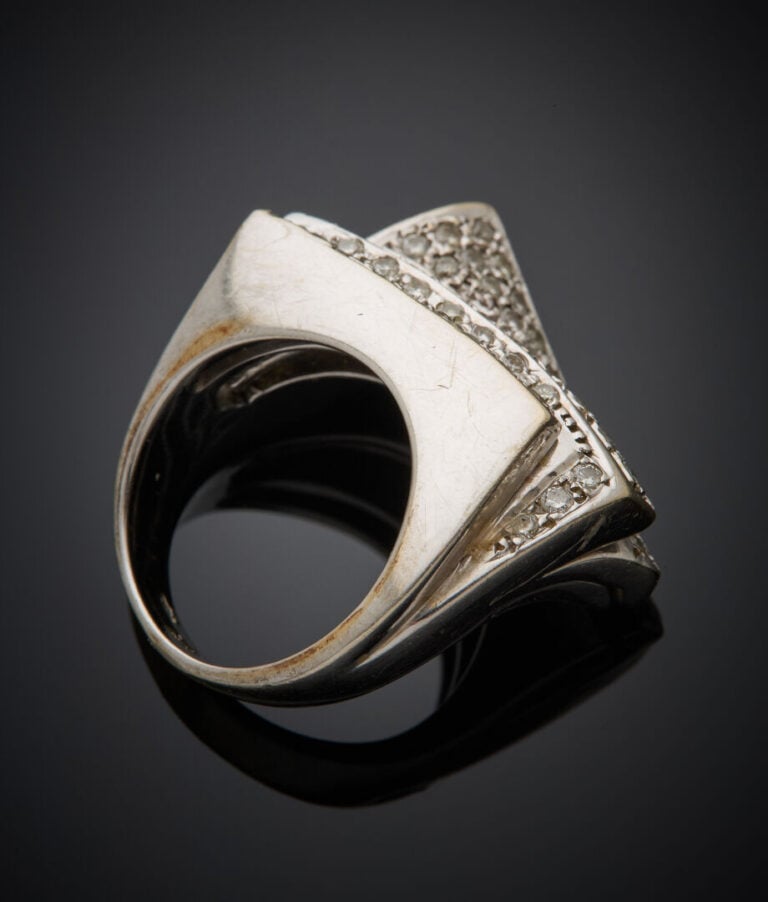 BAGUE stylisée "feuilletée et courbée" en or gris (750‰) serti d'alignements de…