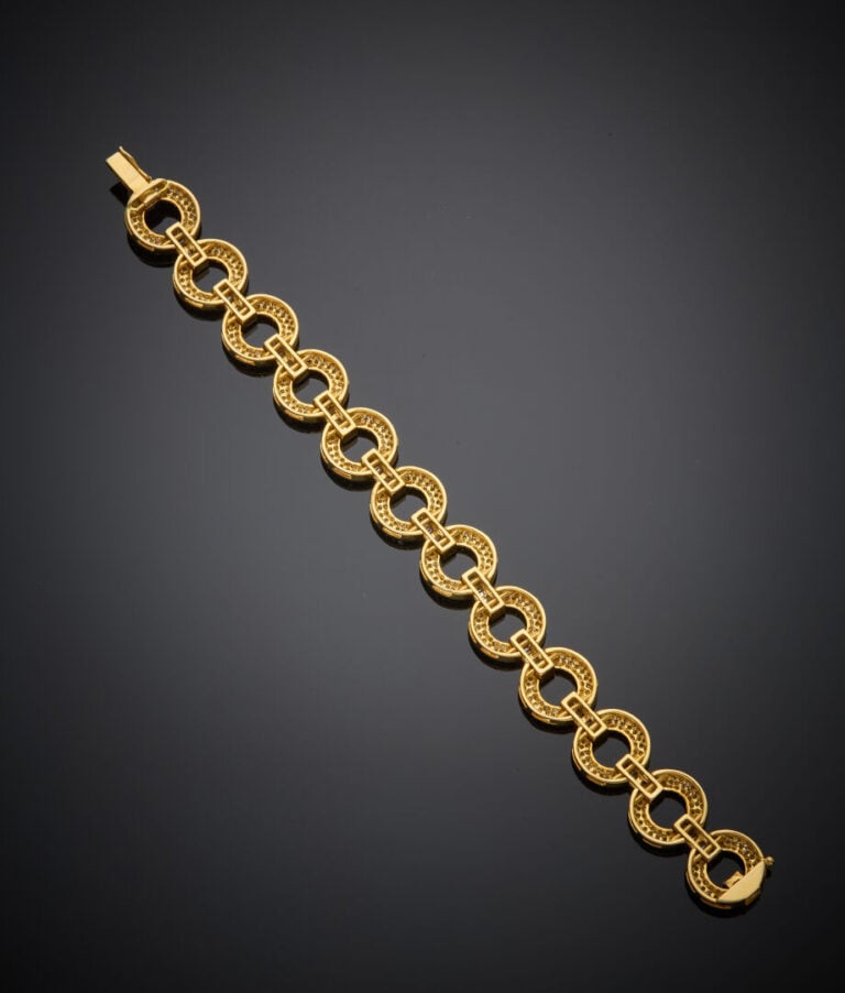 BRACELET en or jaune (750‰) à maillons circulaires, serti de diamants taille br…