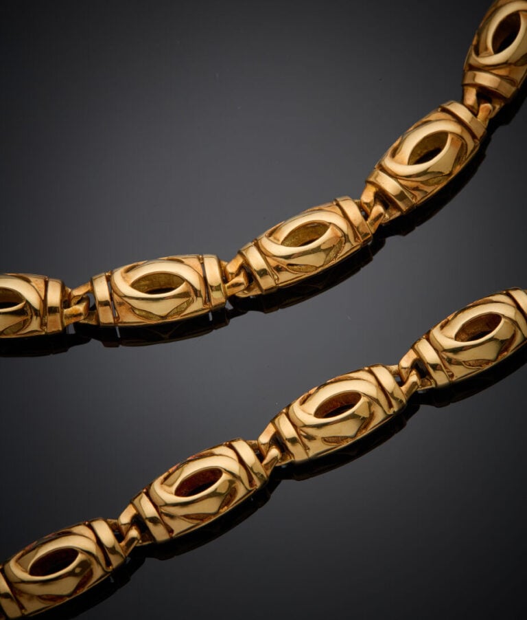 CARTIER - - DEMI-PARURE en or rose (750‰) ajouré, composée d"un COLLIER et un B…