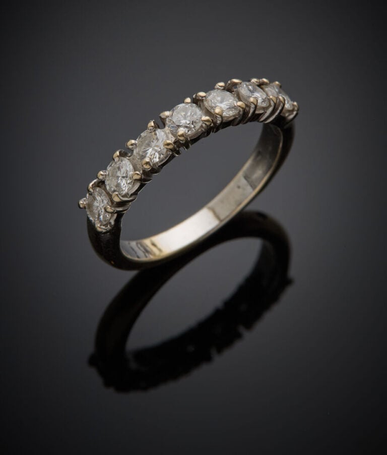 DEMI-ALLIANCE en or gris (750‰) serti de sept diamants taille brillant. - Trava…
